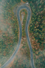 Serpentine roads in Ukraine, fog in the mountains, serpentine road in the fog, drove on top of the road.