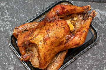 Roasted turkey with oranges, rosemary and cranberries on the Christmas table. Top view with copy space.