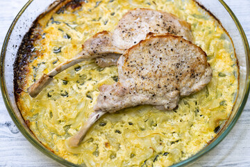 seared pork chop roasted on creamy onion