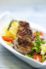 minced veal steaks with mashed potatoes and salad