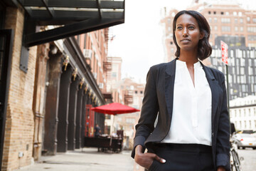 A woman in thought looks away.