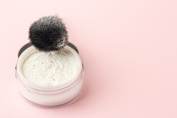 A jar of white face powder on a gentle background.