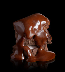 Melted chocolate on a black background with reflection.