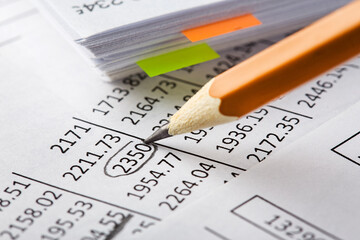 Accounting document with pencil and checking financial chart. Concept of banking, financial report and financial audit.