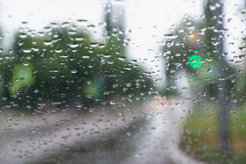 Rain behind the glass of the car. Concept: bad weather, poor visibility, downpours, danger driving a car, after rain.