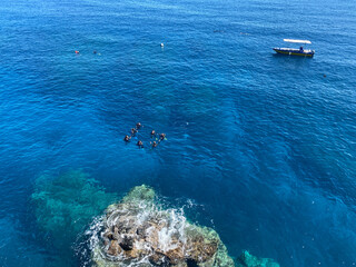 People waiting to start scuba diving in beautiful blue water of Reunion island