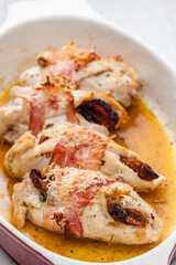 chicken rolls stuffed with dry tomatoes in bacon