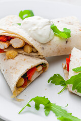 tortilla filled with chicken meat, red pepper and beans