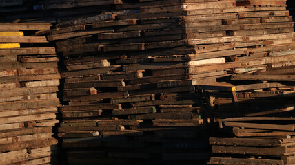 industrial wooden block stack in sunrise.