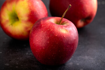 Fresh Red apples on rustic black background