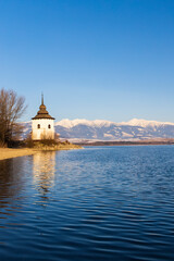 Obraz premium Church of Virgin Mary in Havranok and lake Liptovska Mara, district Liptovsky Mikulas, Slovakia