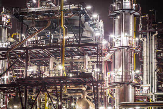 Rafinery In The Night. Chemical Industry Equipment - Fractionating Column With Pipes