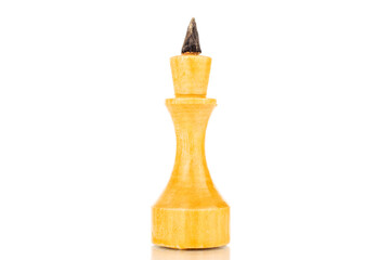 One old wooden chess piece in white, macro, isolated on a white background.