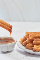 Mexican churros served on a homemade plate.