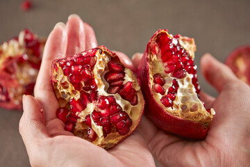 Ripe pomegranate grains in hand
