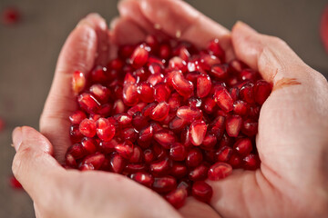 pomegranate seeds in hand
