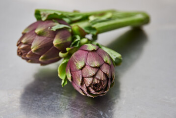 Obraz premium fresh artichokes on the steel table