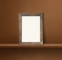 Wooden picture frame leaning on a brown shelf. 3d illustration. Square background