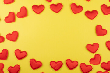 Fototapeta premium Valentine day yellow paper background with red hearts background. Valentines day or love concept, copy space
