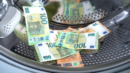 Euro money banknotes in washing machine - illegal cash 50, 100 €  and mafia money laundering -...
