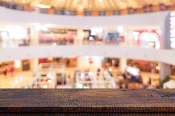 Empty wood table top and blur of shopping mall background. Used for montage product display