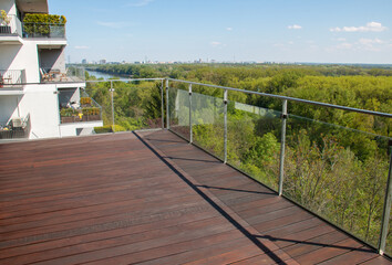 Balcony view with exotic grooved cumaru wood decking and panel glass railing contemporary...