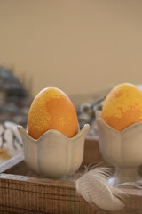 Dyed Easter eggs with marble stone effect painted with natural dye by turmeric on old background