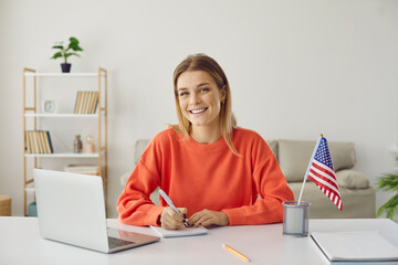 Student at desk studying free online American university academic course during global Covid 19...