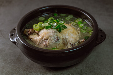 Samgyetang, Korean Ginseng Chicken Soup : Tender, whole, young chicken stuffed with ginseng, jujubes, sweet rice, and whole garlic cloves and simmered until tender. The combination of chicken and gins