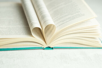 an open book with folded pages in the shape of a heart 