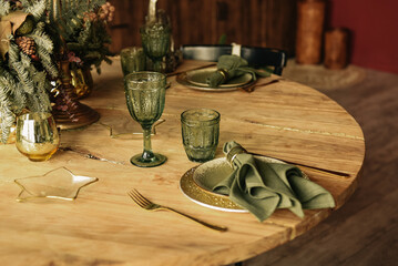 Rustic kitchen, serving wooden table and green vintage glasses