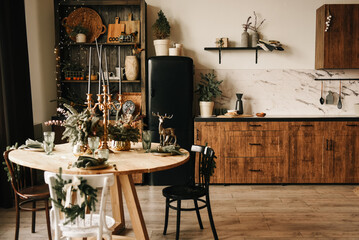 Rustic kitchen with wooden table and facades decorated for Christmas
