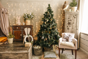 The stylish interior of the children's room with wooden furniture and a rustic wigwam is decorated for Christmas