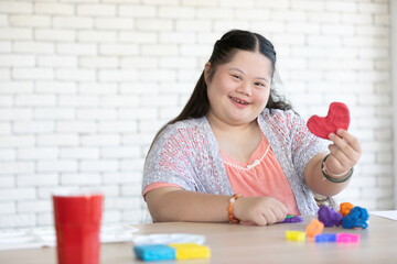 down syndrome girl sculpt and looking red heart plasticine figures