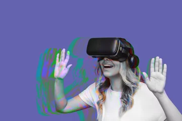 Photo sur Plexiglas Pantone 2022 very peri A young blonde excited woman in a white t-shirt looking into black virtual reality glasses isolated on abstract very peri color background. Trendy design in magazine style. VR gadget