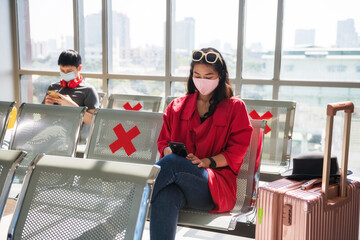 woman in face mask using phone, wait to departure