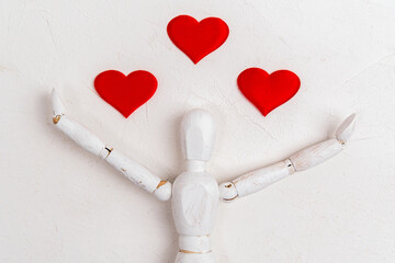 Wooden man heart figurine on white background. Wooden mannequin. Valentines day concept.