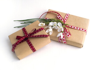 gift boxes, a bouquet of snowdrops on a white background. gift for 8 march, congratulations on mother's day