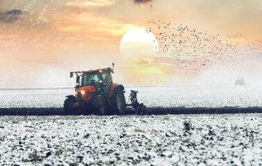 Tractor plowing a field in winter