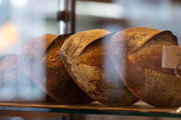loaves of bread through bakery window