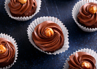 Meringue, pavlova chocolate cupcakes with cream and nuts