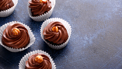 Meringue, pavlova chocolate cupcakes with cream and nuts