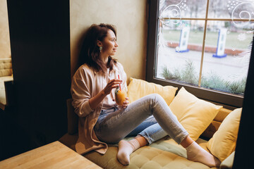 Obraz na płótnie Canvas Brunette woman in cafe drink vitamin fresh