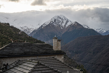 Chimneys of old stone houses on the mountain at the traditional village of Syrrako in Tzoumerka, Greece