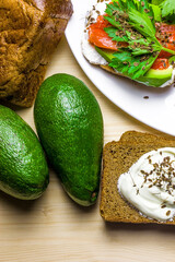 Sandwiches with avocado, trout and sour cream, sprinkled with spicy dill. Celery leaves.