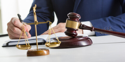 Lawyer working with contract papers and wooden gavel on tabel in courtroom. justice and law...