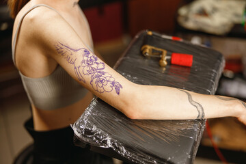 Close up photo of client female hand with sketch for tattoo on the skin