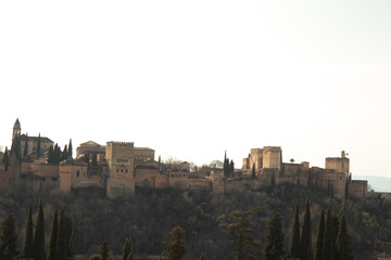view of Alhambra Palace in Granada, Spain with Sierra Nevada mountains at the background during the sunny day