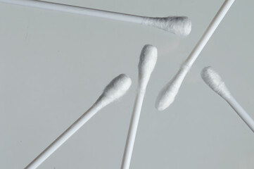 Heap of cotton swabs on a white background, hygienic cosmetic and medical supplies.