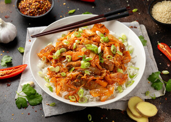 Korean Stir Fried pork belly kimchi with rice and spring onion. Asian food style